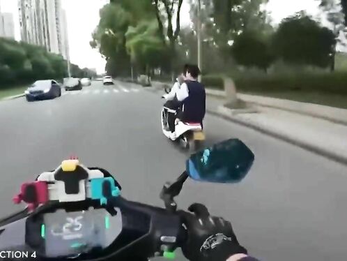 Motorcyclist Giving Middle Finger To Moped Driver