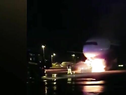 Firefighters Battle To Save Plane As Truck Tows Away Passenger Jet