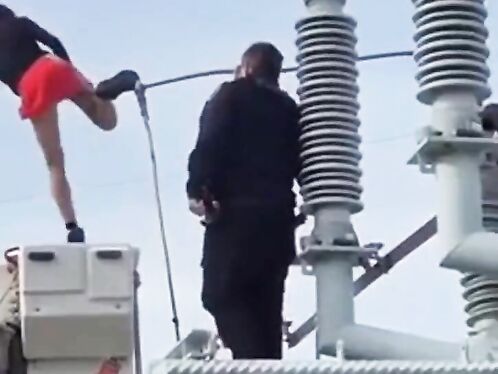 Woman Climbs On Transformer At Substation
