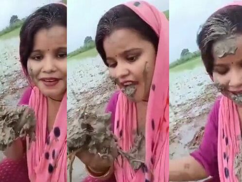 A Woman Eating Dirt From A Field
