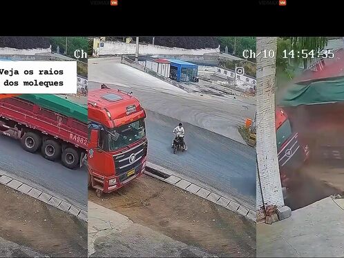 Two Boys Riding A Motorcycle Recklessly On The Street