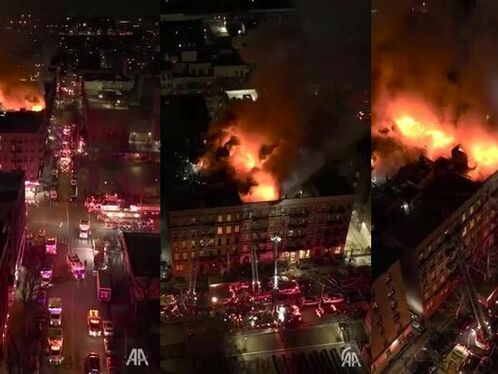 New York City Firefighters Take In The 4-alarm Fire In Harlem From An Aerial View