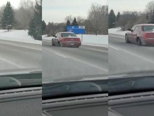 Cadillac Driving Slowly On The Highway