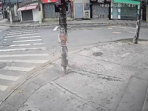 Note The Man In Red On The Sidewalk In The Upper Left Corner.