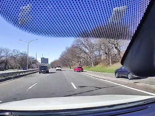A Slow-moving Cyclist Caused A Red Car To Change Lanes Prematurely.