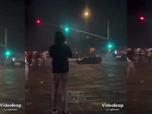 Skater does a blazing burnout on a crowded street at night