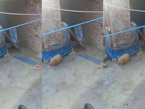 Man attempts to walk a tightrope between balconies and falls.