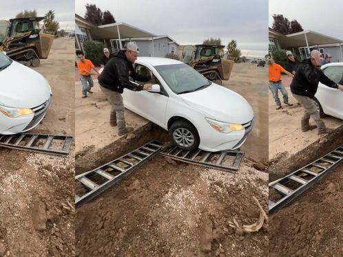 Man helps driver get stuck car out of mud