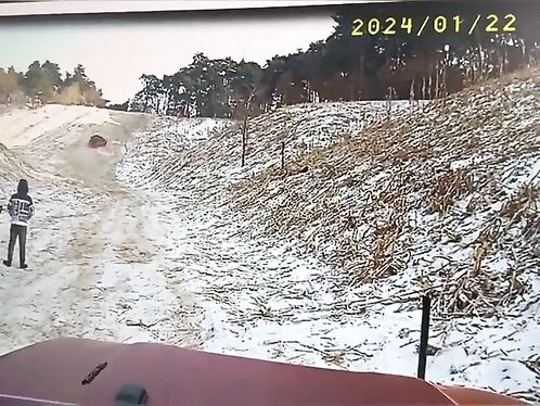 Truck rolls down a muddy, snowy hillside
