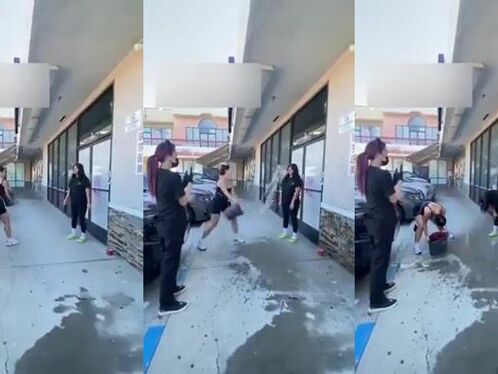 Woman accidentally splashes water onto herself while cleaning