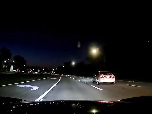 Two cars dangerously race on busy night road