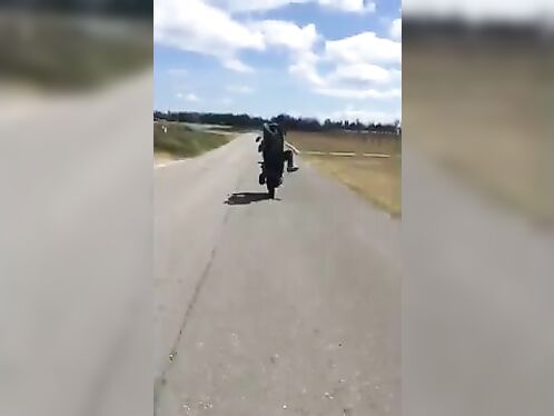Man performs insane wheelie on a motorcycle