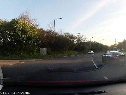 A pickup truck nearly collides with cars on a busy intersection