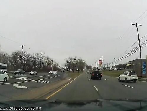 Driver swerves to avoid head-on collision on busy street