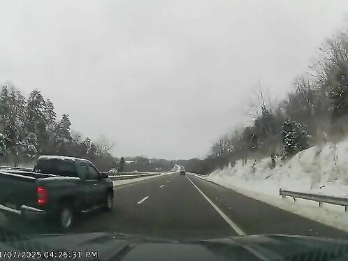 Truck flips over and rolls down embankment