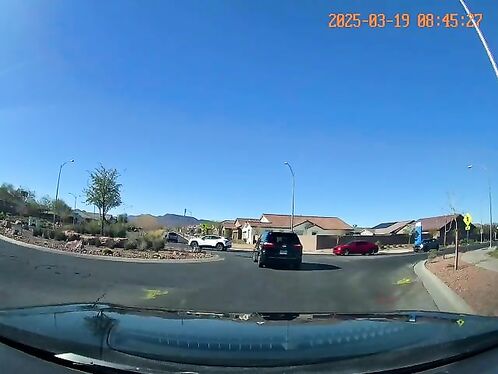 Red sports car flips over after avoiding collision with truck