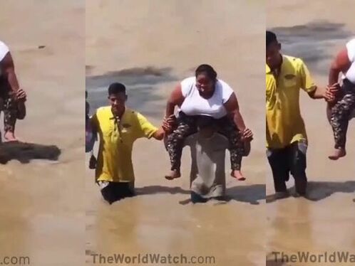 Husband Piggybacks Wife Across Wet Beach
