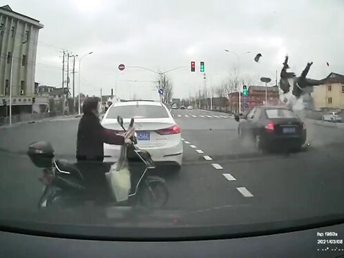 Scooter rider jumps red light and crashes into a car