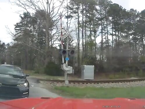 Driver narrowly avoids being hit by a train
