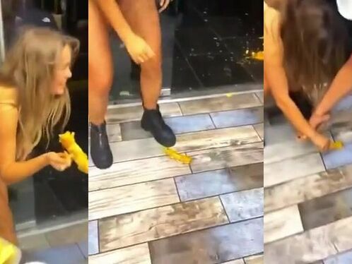 Woman bends over to pick up yellow object and shows off her ass
