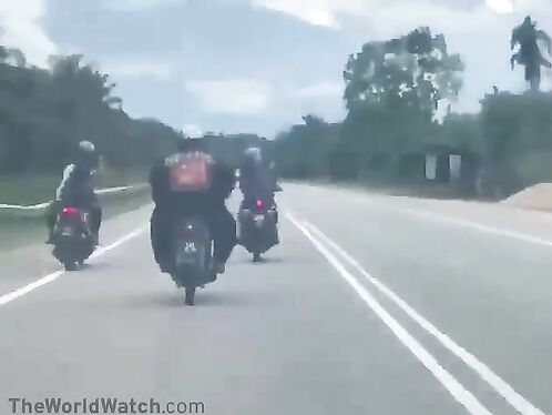 Biker does a faceplant on the highway in front of his friends