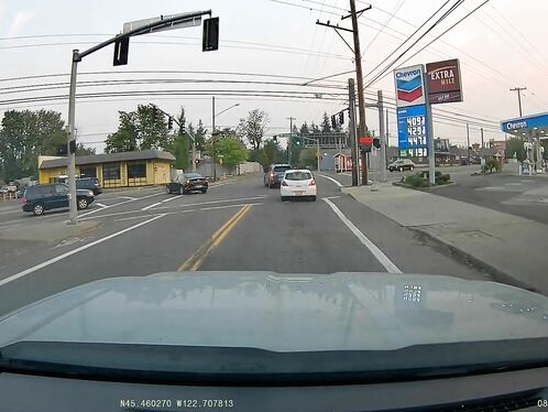 Car vaults over curb into a busy street