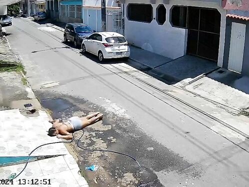 Man collapses face-first on street and rolls around