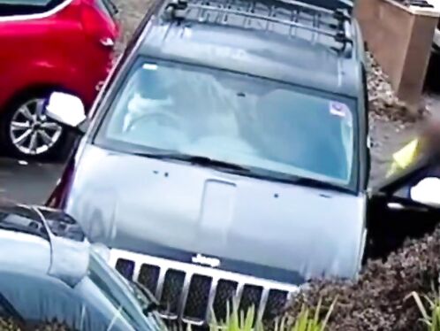 SUV driver rolls over the curb in parking lot