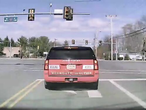 Officer stalls at a green light causing traffic backup