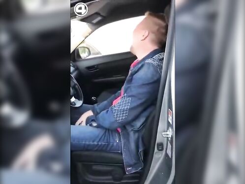 Man falls asleep in the driver's seat of a moving car