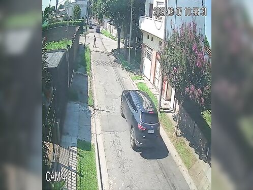 Car Swerves to Avoid Pedestrian on Residential Street