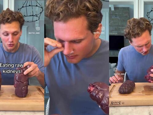 Man eats a giant chocolate chip cookie