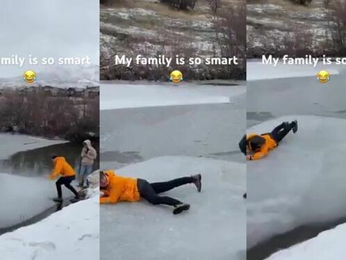 Two people on skis fall on ice
