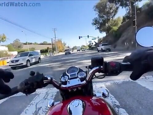 Motorcycle rider makes a quick turn to avoid collision
