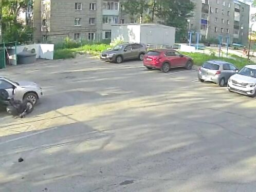 Man on motorcycle wipes out in crowded parking lot