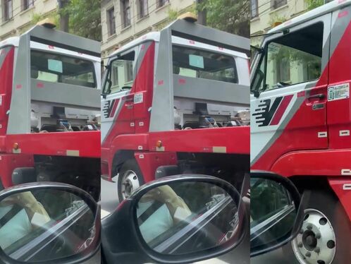 Worker uses power tool to cut through a truck