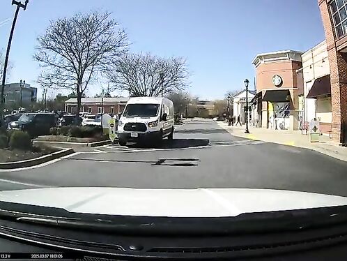 White van tries to force its way through a narrow street