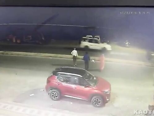 Man throws frisbee at car on busy street