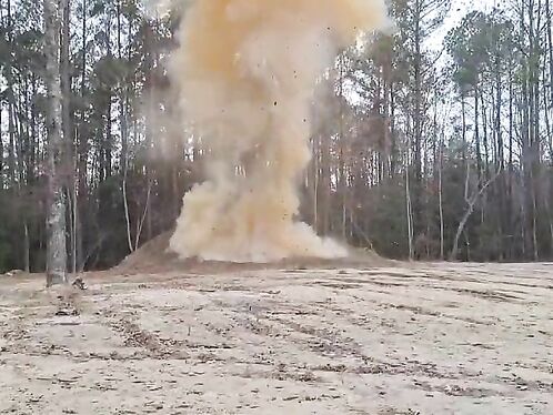 Large explosion sends debris flying in the forest