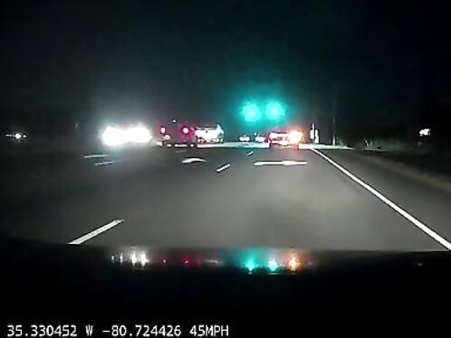 Car crashes into police vehicle on busy intersection