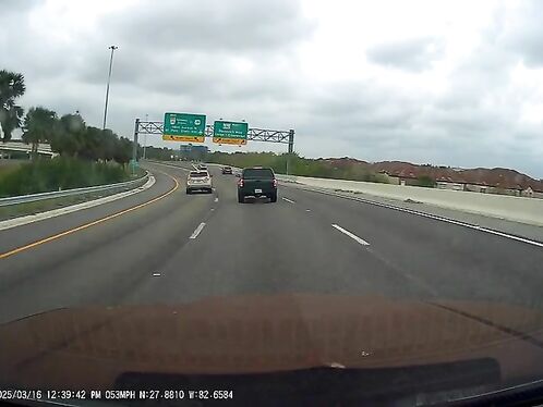 SUV cuts off car in heavy traffic on the highway