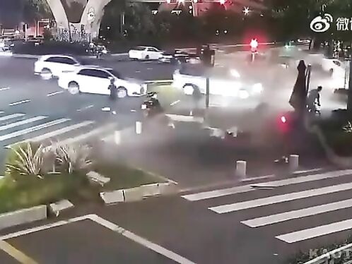 A car plows through a busy intersection