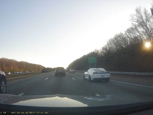 Fast car overtakes in a high-speed lane change on the highway