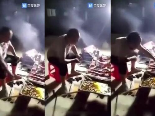 Man eats food straight from the grill at market