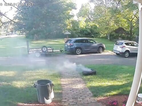 SUV drags trailer tire and sparks fly in parking lot