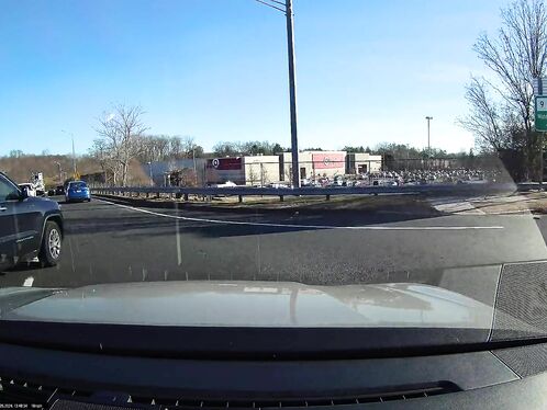Car suddenly makes U-turn in the middle of the road.