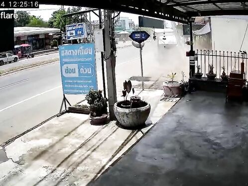Man watches surveillance footage of a truck hit by a motorbike