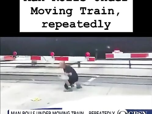 Man rolls under moving train at railroad crossing