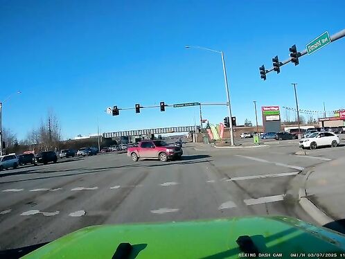 Driver turns left on red from center lane