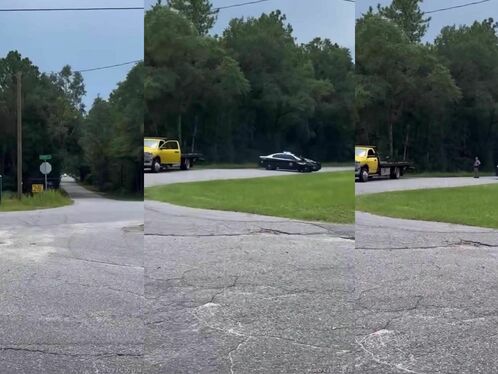Wrecked car rolls into grassy area, tow truck arrives